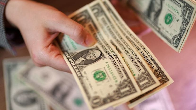 Dollar holds steady on safe-haven demand, ends down on the week