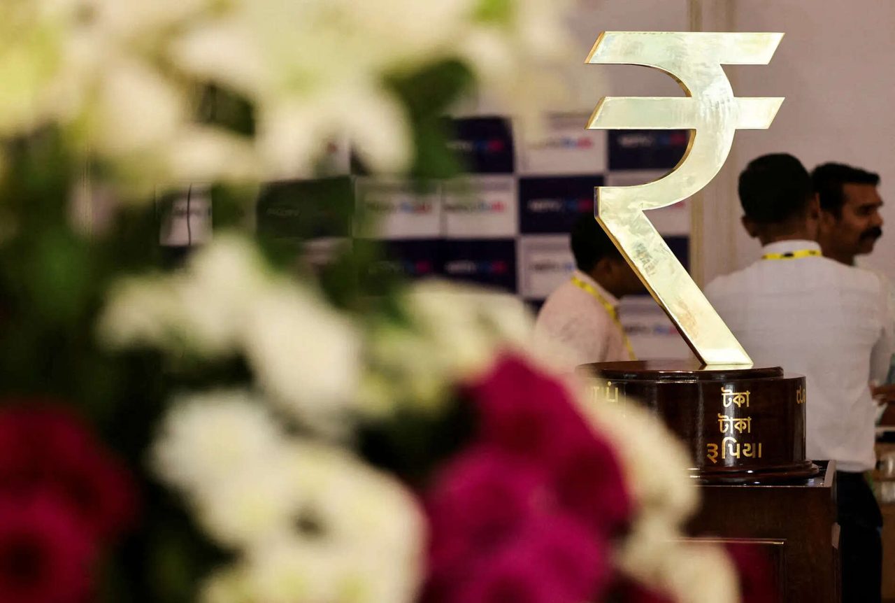 Rupee edges up as options traders price in elevated oil risk