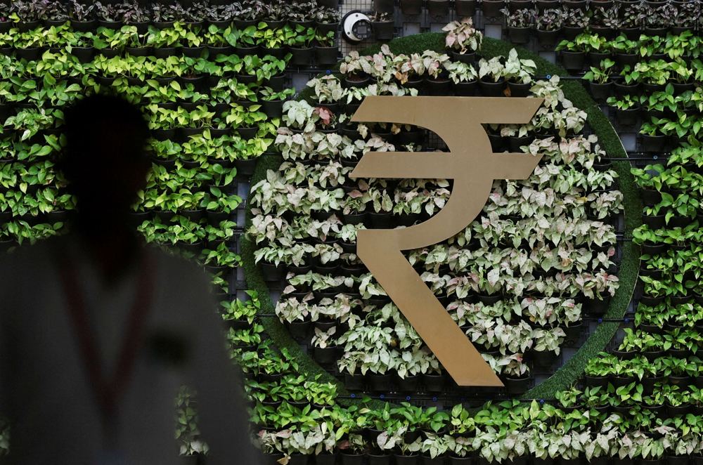 Rupee edges up on RBI support, softer oil prices